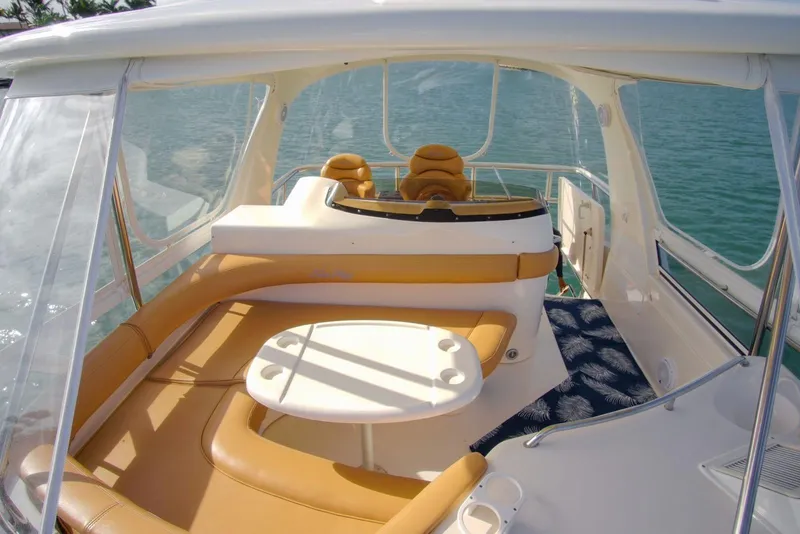 Slide: The Image of Luxurious 2001 Sea Ray 480 Sedan Bridge yacht interior with tan seating and table. - 38