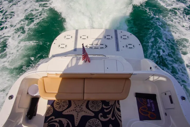 Slide: The Image of 2001 Sea Ray 480 Sedan Bridge cruising with wake, featuring a comfortable rear seating area. - 43