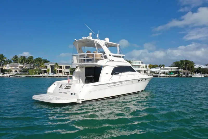 Slide: The Image of 2001 Sea Ray 480 Sedan Bridge yacht on clear blue water, sunny day. - 8