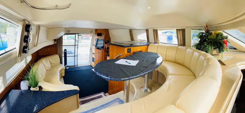 Slide: The Image of Luxurious interior of a 2002 Carver 410 Sport Sedan yacht with elegant seating and decor. - 10