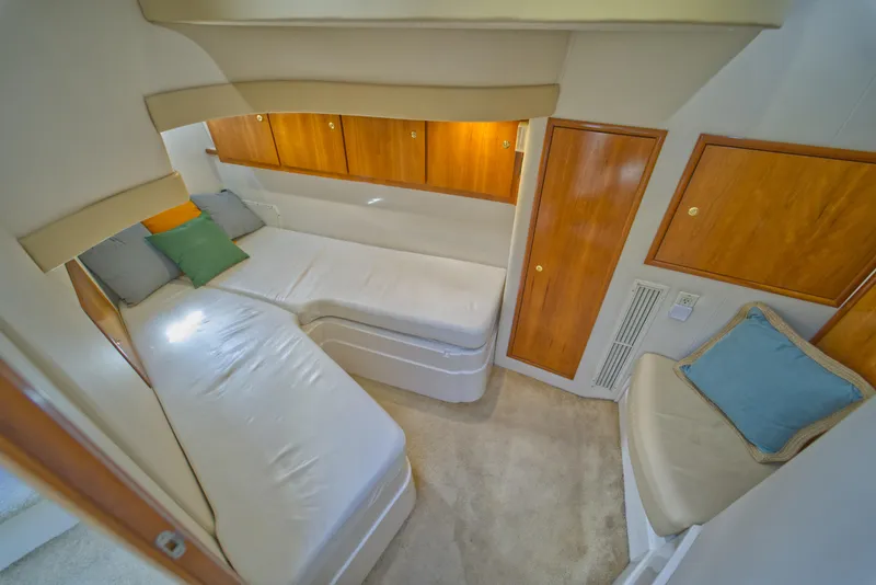 Slide: The Image of Interior cabin of 2002 Carver 410 Sport Sedan with cozy seating and wooden cabinets. - 12