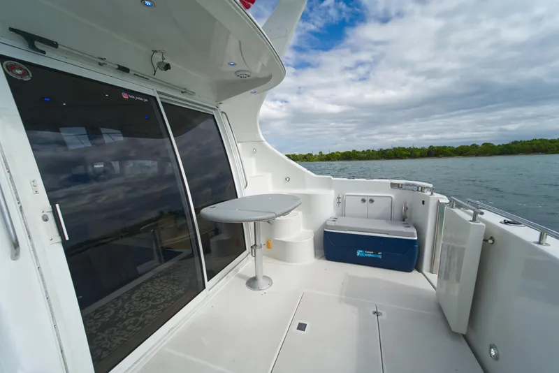 Slide: The Image of 2002 Carver 410 Sport Sedan yacht deck with table, seating, and ocean view. - 16