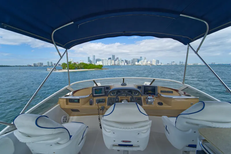 Slide: The Image of 2002 Carver 410 Sport Sedan yacht cockpit with city skyline view. - 4