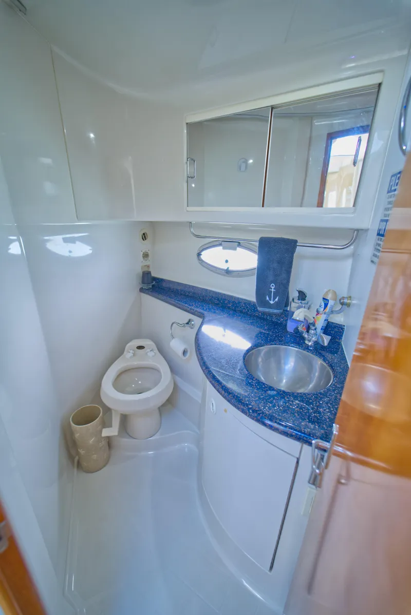 Slide: The Image of 2002 Carver 410 Sport Sedan bathroom with sink, toilet, and mirror. - 11