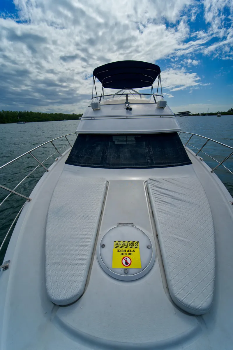 Slide: The Image of 2002 Carver 410 Sport Sedan yacht on water under cloudy sky. - 17
