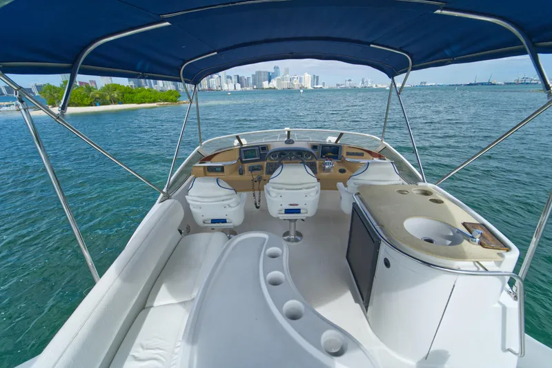 Slide: The Image of 2002 Carver 410 Sport Sedan yacht interior with ocean view and city skyline. - 6