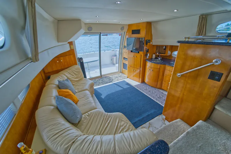 Slide: The Image of Luxurious interior of 2002 Carver 410 Sport Sedan yacht with plush seating and kitchenette. - 8