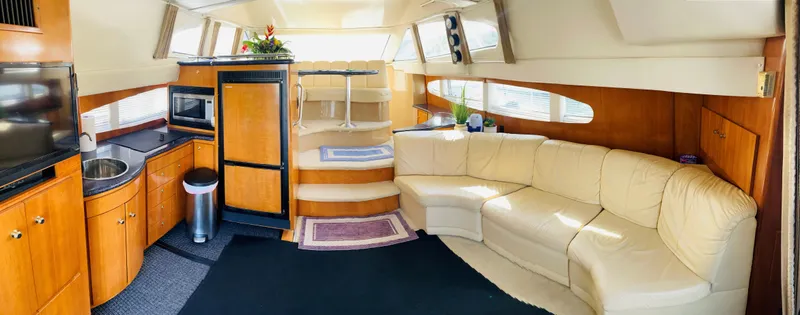 Slide: The Image of Interior of 2002 Carver 410 Sport Sedan with kitchen and seating area. - 9