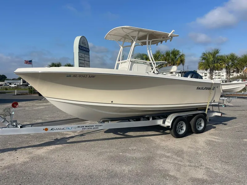 Slide: The Image of 2016 Sailfish 220 CC boat on trailer in parking lot, clear sky background. - 1