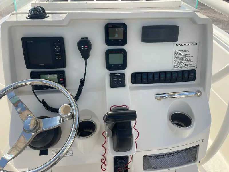 Slide: The Image of 2016 Sailfish 220 CC boat dashboard with steering wheel and electronic controls. - 10