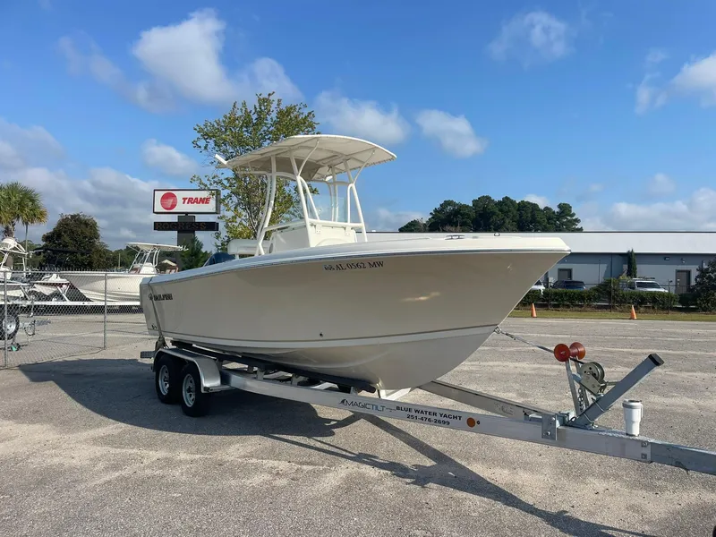 Slide: The Image of 2016 Sailfish 220 CC boat on trailer in sunny outdoor setting. - 2