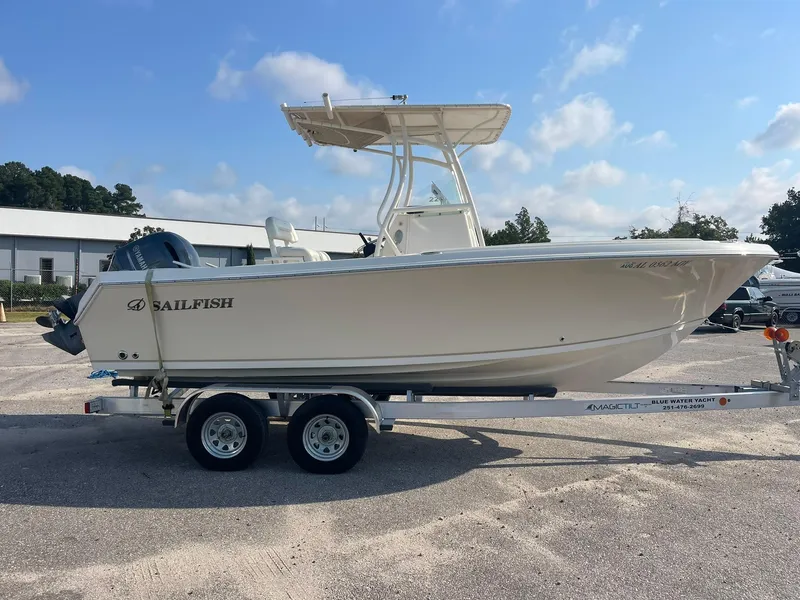 Slide: The Image of 2016 Sailfish 220 CC boat on trailer, parked outdoors under blue sky. - 3
