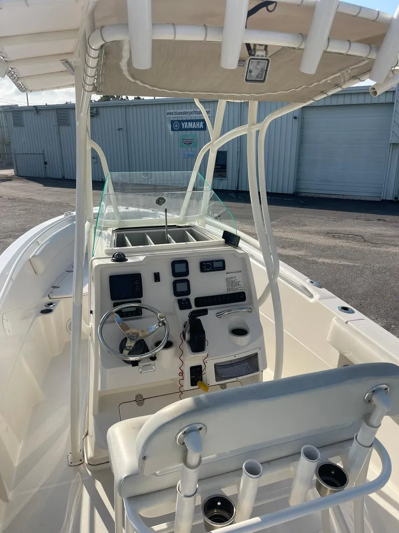 Slide: The Image of 2016 Sailfish 220 CC boat interior with steering console and seating. - 4
