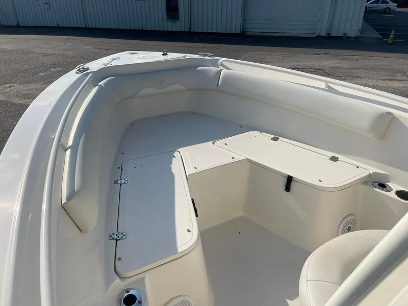 Slide: The Image of 2016 Sailfish 220 CC boat interior with white seating and storage compartments. - 6