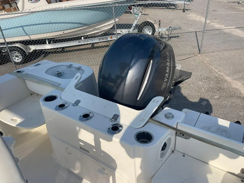 Slide: The Image of 2016 Sailfish 220 CC boat with Yamaha outboard motor, docked in a marina. - 9