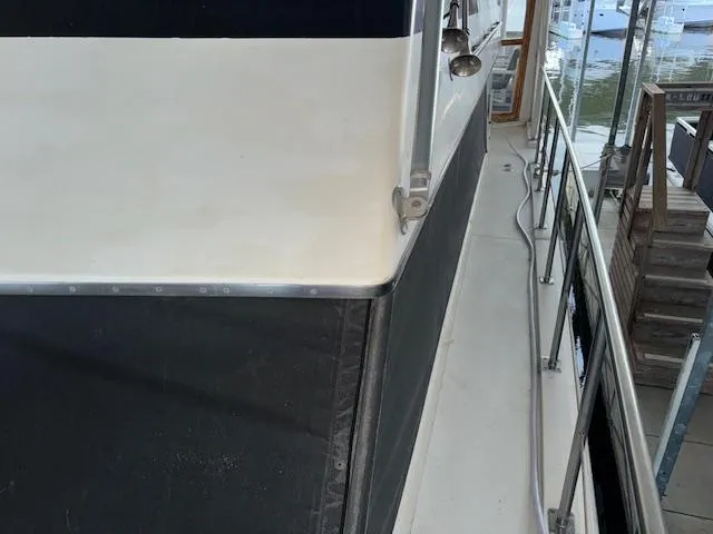 Slide: The Image of 1987 Seamaster 48 Motor Yacht deck view with railing and dockside perspective. - 10