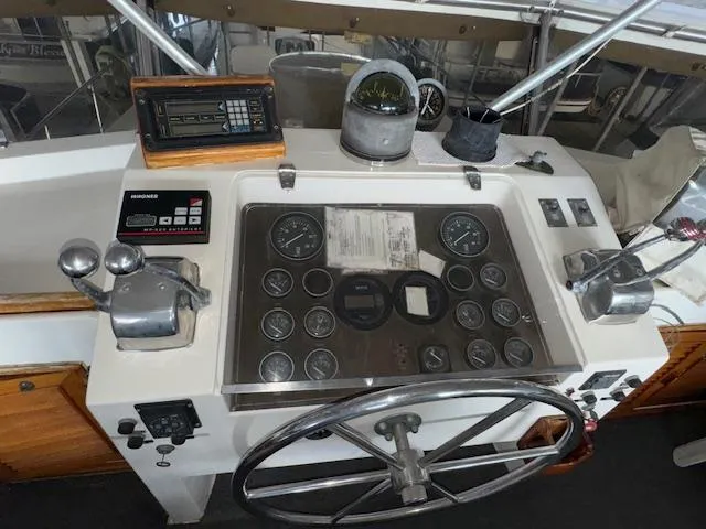 Slide: The Image of Control panel of a 1987 Seamaster 48 Motor Yacht with gauges and steering wheel. - 13