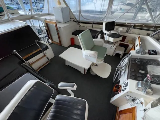 Slide: The Image of 1987 Seamaster 48 Motor Yacht interior with seating, helm, and navigation equipment. - 15