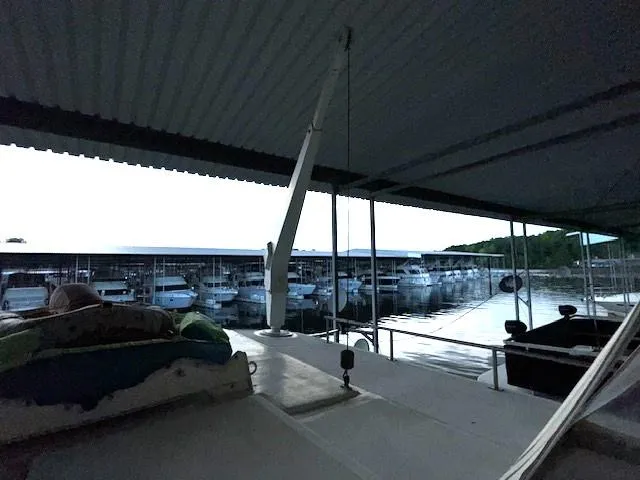 Slide: The Image of 1987 Seamaster 48 Motor Yacht docked in a marina under a covered structure. - 16