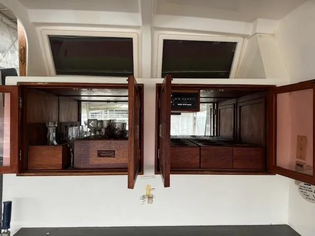 Slide: The Image of 1987 Seamaster 48 Motor Yacht interior with open wooden cabinets and glassware. - 25