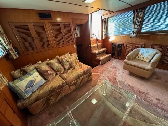 Slide: The Image of 1987 Seamaster 48 Motor Yacht interior with cozy seating, wooden paneling, and natural light. - 30