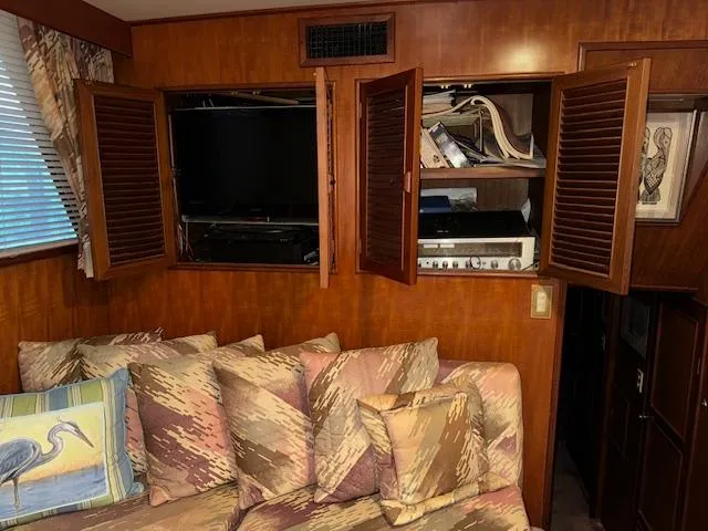 Slide: The Image of Interior of 1987 Seamaster 48 Motor Yacht with wooden cabinets and patterned sofa. - 32