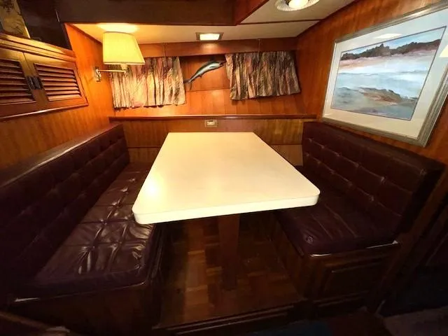 Slide: The Image of Cozy dining area in 1987 Seamaster 48 Motor Yacht with wood paneling and leather seating. - 34
