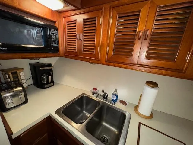 Slide: The Image of Galley kitchen in 1987 Seamaster 48 Motor Yacht with wooden cabinets and appliances. - 38