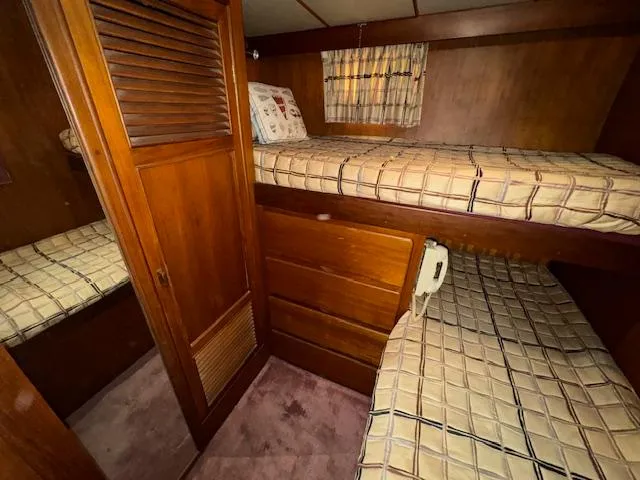 Slide: The Image of Cozy cabin interior of 1987 Seamaster 48 Motor Yacht with wooden furnishings and bunk beds. - 46