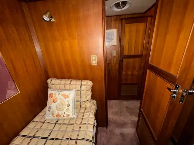 Slide: The Image of 1987 Seamaster 48 Motor Yacht interior with wooden paneling and cozy bed. - 47