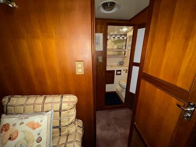 Slide: The Image of 1987 Seamaster 48 Motor Yacht interior with wood paneling and cozy seating area. - 48