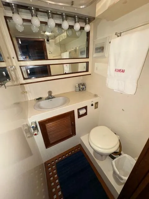 Slide: The Image of 1987 Seamaster 48 Motor Yacht bathroom with sink, toilet, mirror, and towel. - 49