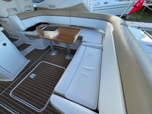 Slide: The Image of 2009 Four Winns V435 yacht interior with white seating and wooden table. - 10