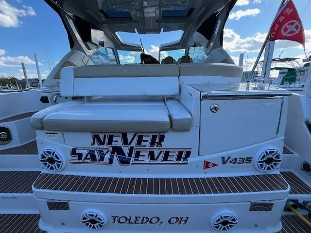 Slide: The Image of 2009 Four Winns V435 boat with "Never Say Never" text, docked in Toledo, OH. - 12