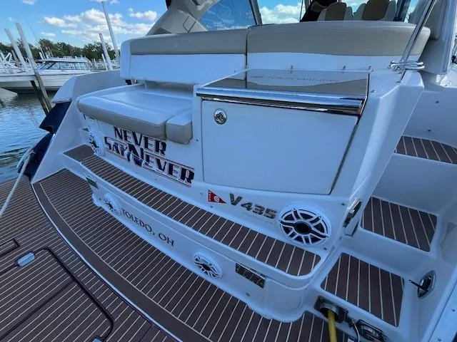Slide: The Image of 2009 Four Winns V435 boat with "Never Say Never" text, docked in Toledo, Ohio. - 13
