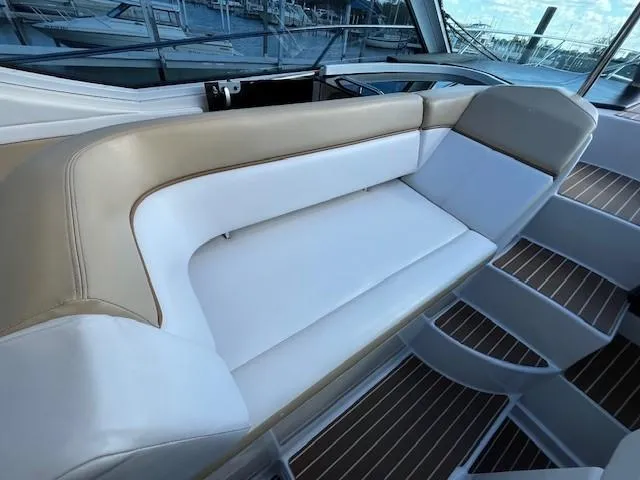 Slide: The Image of 2009 Four Winns V435 boat interior with white and beige seating. - 15