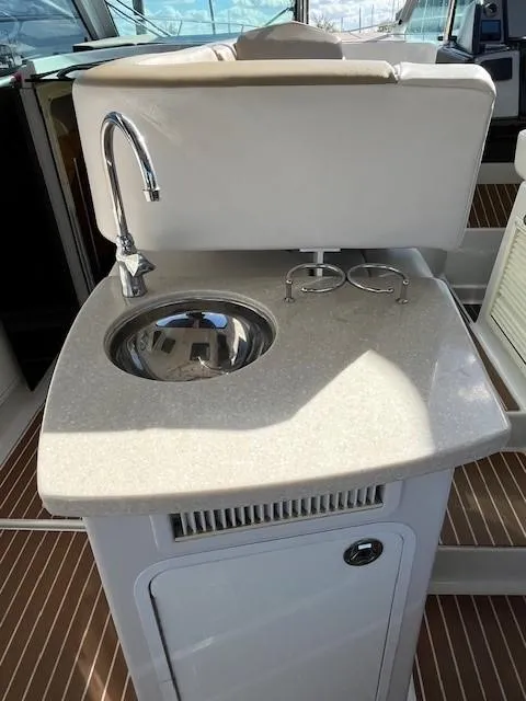 Slide: The Image of 2009 Four Winns V435 yacht kitchenette with sink and countertop. - 16