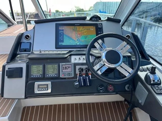 Slide: The Image of 2009 Four Winns V435 boat dashboard with navigation system and steering wheel. - 21