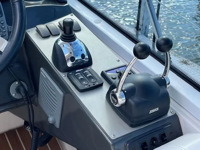 Slide: The Image of 2009 Four Winns V435 boat controls with dual throttle levers and joystick. - 22