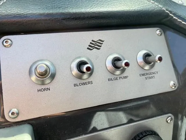 Slide: The Image of Control panel of 2009 Four Winns V435 boat with switches for horn, blowers, bilge pump, emergency start. - 30
