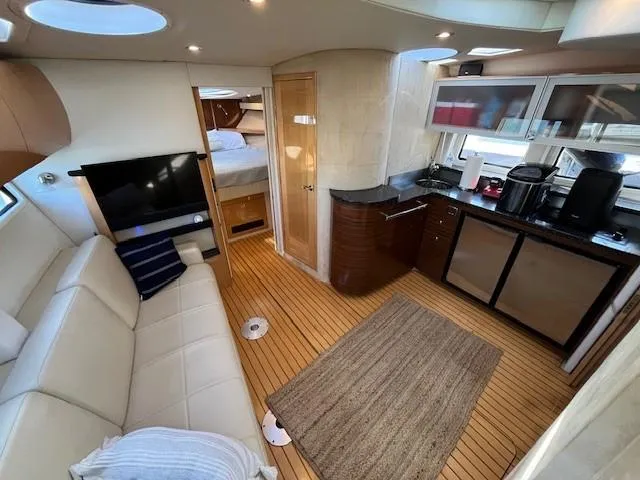 Slide: The Image of Luxurious 2009 Four Winns V435 yacht interior with modern kitchen and cozy seating area. - 38