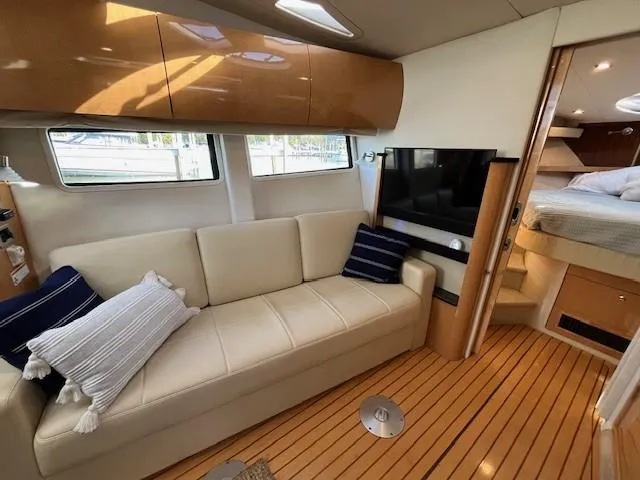Slide: The Image of Luxurious 2009 Four Winns V435 yacht interior with sofa, TV, and bedroom. - 41