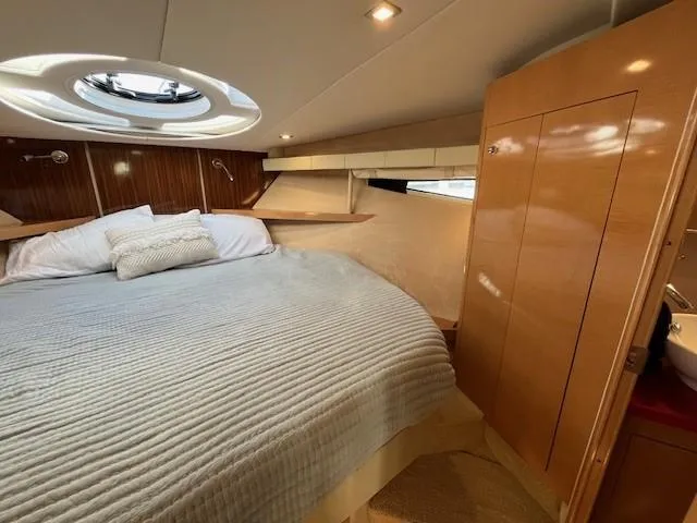 Slide: The Image of Luxurious 2009 Four Winns V435 yacht bedroom with cozy bedding and elegant wood finishes. - 45