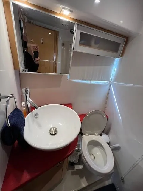 Slide: The Image of 2009 Four Winns V435 yacht bathroom with modern sink and toilet. - 48