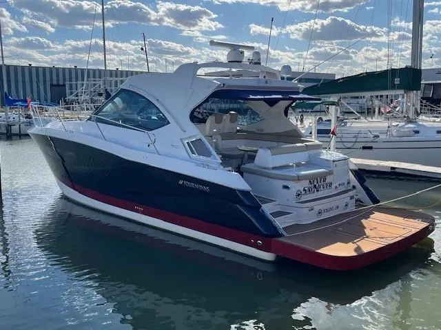 Slide: The Image of 2009 Four Winns V435 yacht docked in marina under cloudy sky. - 5