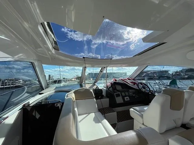 Slide: The Image of Interior view of 2009 Four Winns V435 yacht with panoramic windows and plush seating. - 9