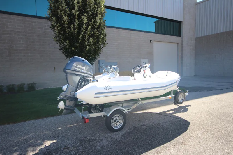 Slide: The Image of 2025 Zodiac Yachtline 360 DL NEO with 40hp engine on trailer, parked outdoors. - 3