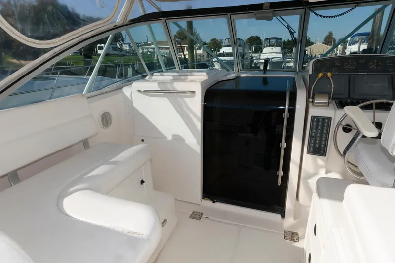Slide: The Image of 2000 Pursuit 3400 Express boat interior with seating and helm station. - 10
