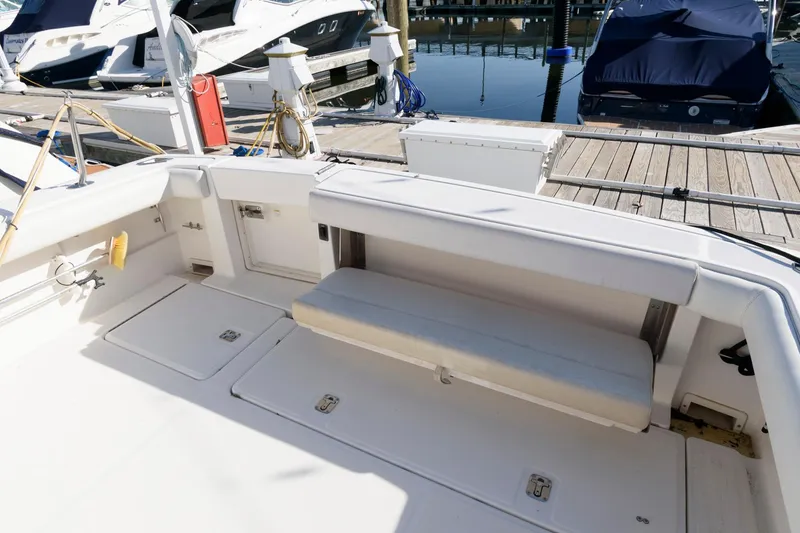 Slide: The Image of 2000 Pursuit 3400 Express boat interior with seating and dock view. - 11