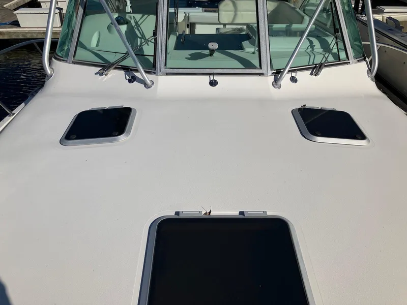 Slide: The Image of 2000 Pursuit 3400 Express boat deck with hatches and windshield. - 13